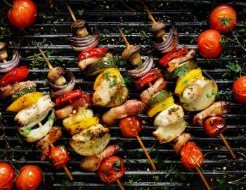 Kabobs being cooked over a grill