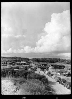 line of cars awaiting the old ferry holden beach